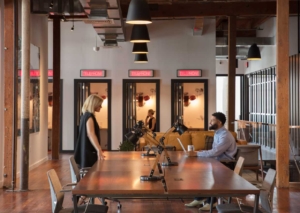 Large meeting table with professionals collaborating at New Orleans' Shops Workspace