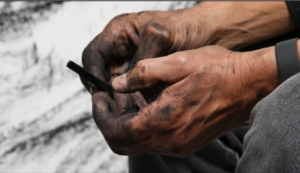 hands covered in charcoal