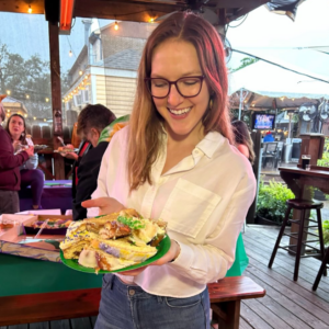member spotlight on liza smith, pictured holding king cake