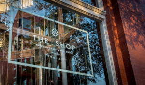 the shop nola logo on a window