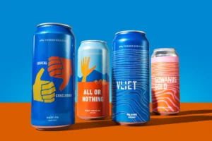 Assortment of Threes Brewing craft beer cans with bold designs in Gowanus, Brooklyn