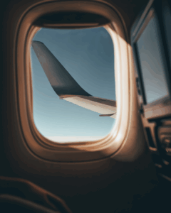 Frequent Flyer Airplane window view with sunset