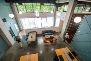 Overlooking Commons workspace with communal and private desks, lounge seating, and banquettes