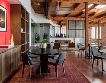 Open commons area at The Shop New Orleans coworking space with shared work areas and modern design