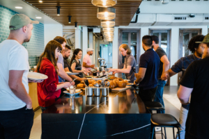 Multi-city coworking team working together in a design-forward coworking space.